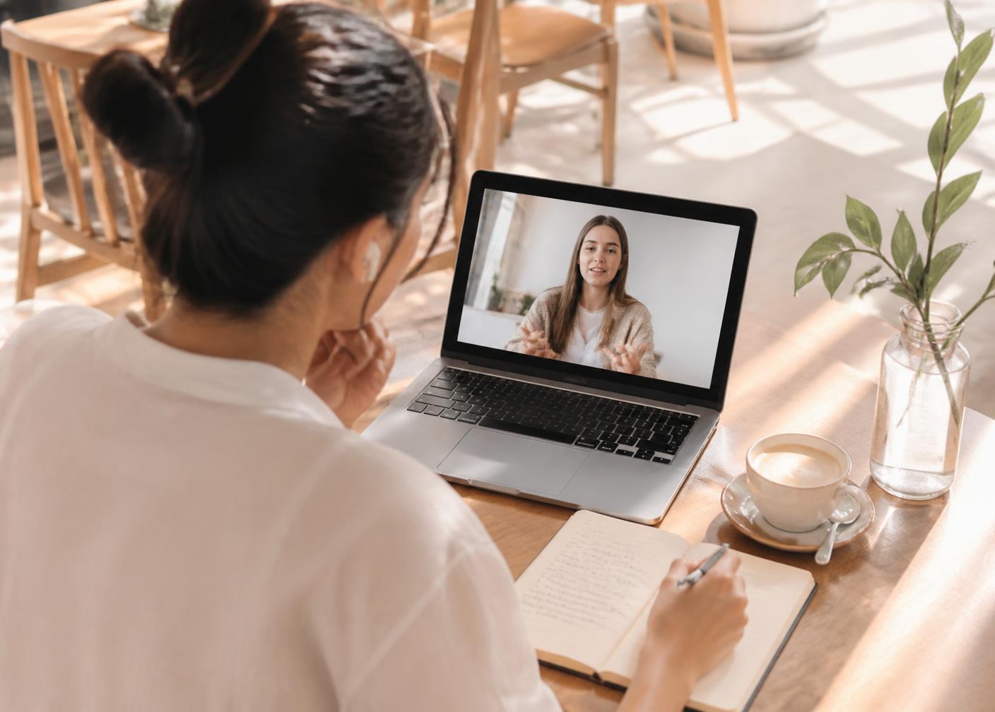 A student taking a private online Thai lesson on a laptop